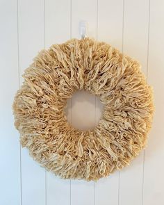 a wreath hanging on the side of a white wall