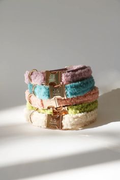 four different colored bracelets on top of each other