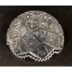 an antique crystal dish with scalloped edges