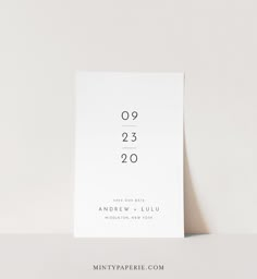 a white wedding card with the numbers twenty and twenty on it's front side