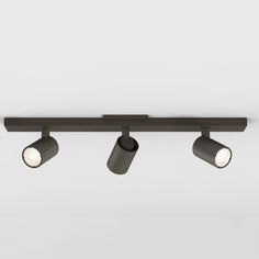 three spotlights are mounted on the ceiling in an industrial style lighting fixture with black finish