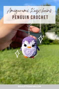 a small crocheted penguin keychain hanging from a person's hand