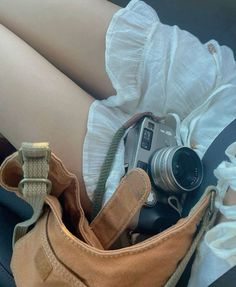 a person's legs are shown with shoes and camera