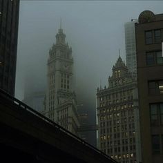 fog covers the city skyline with tall buildings