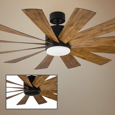 a ceiling fan with wooden blades hanging from it's center and the light bulb turned on