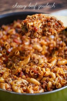 a wooden spoon full of cheesy beef and pasta casserole with text overlay