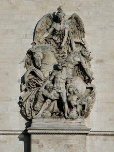 a statue on the side of a building