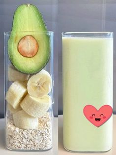 an avocado, banana, and heart in a glass next to a bottle of milk