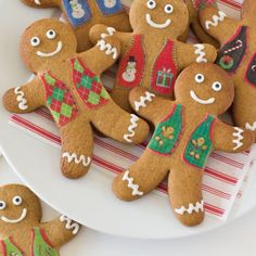 several decorated gingerbreads on a white plate