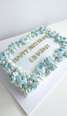 a birthday cake with blue frosting and gold lettering