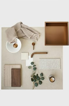 an overhead view of various materials and accessories on the floor, including a tray with leaves