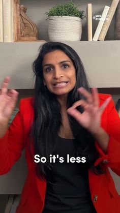 a woman sitting in front of a book shelf with her hands up and the words so it's less