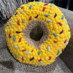 a crocheted donut sitting on top of a couch