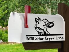 a white mailbox with a black and red sticker on it's side