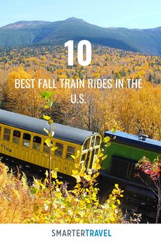 a yellow train traveling through a forest filled with trees and bushes on the side of a mountain