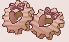 two wooden gears with hearts and bows on them