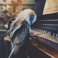 a bird sitting on the edge of a piano