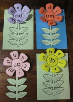 three flower cut outs on top of paper with the words abc and d in them