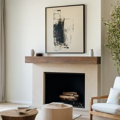 a living room filled with furniture and a painting on the wall over a fire place