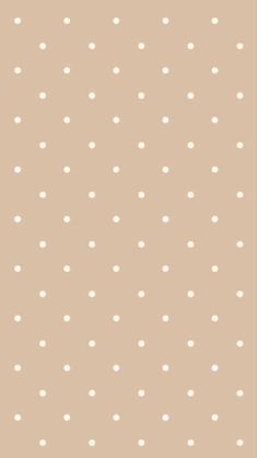 a beige background with white polka dots