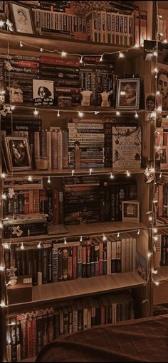 a bookshelf filled with lots of books covered in lights