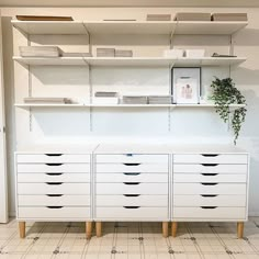 a large white cabinet with drawers and shelves