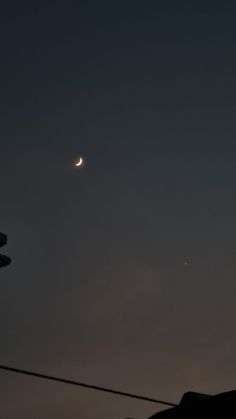 the moon and venus are visible in the night sky