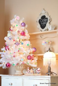 a white christmas tree sitting on top of a dresser