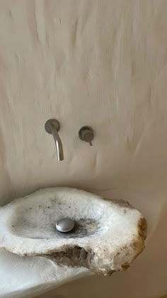 a bathroom sink made out of a piece of drift wood and metal faucet