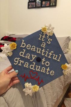 a graduation cap that says it's a beautiful day to graduate with flowers on it