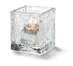 an ice cube is shown on a white background with the light reflecting off it's surface