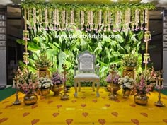 a white chair sitting on top of a yellow floor covered in flowers and greenery