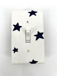 a white light switch with black stars on it