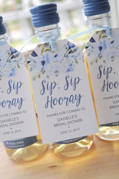 three bottles of sip - sip hooray are sitting on a table with tags