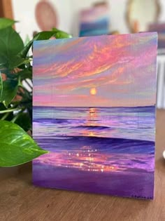 an acrylic painting of a sunset over the ocean with purple and pink colors