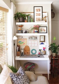 a living room filled with lots of furniture and plants on top of shelves next to a window