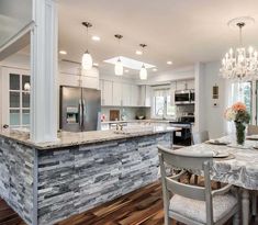 a kitchen and dining room with an island in the middle