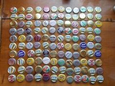 many different colored bottle caps on a wooden table