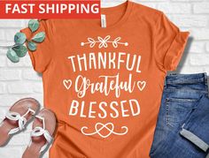 an orange t - shirt with the words, thank grateful and hearts on it next to some