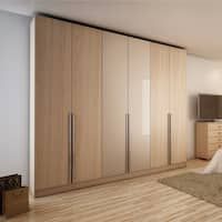 an empty room with wooden floors and large sliding doors on the wall next to a bed