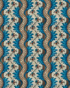 a blue and brown pattern with flowers on it's side, in the middle of an ornate design