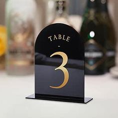 a table number stands in front of bottles