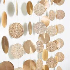 a white wall with gold circles hanging from it