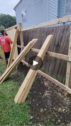 a wooden fence that is being built in the yard