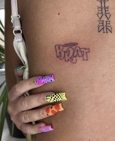 a woman's stomach with tattoos on it and the word booat written in chinese