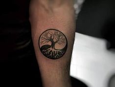 a man with a tree tattoo on his arm