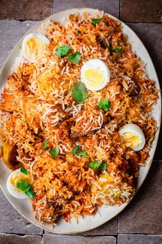 a white plate topped with rice and hard boiled eggs