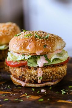 two chicken burgers with lettuce and tomatoes