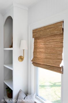 the blinds in this room are made out of bamboo and have been pulled down to reveal an interesting pattern