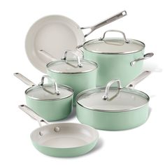 green pots and pans with lids on white background